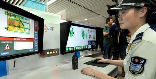 安检员在地铁徐家汇站操作新型液体智能识别报警X光安检仪对进站人群包裹进行检查